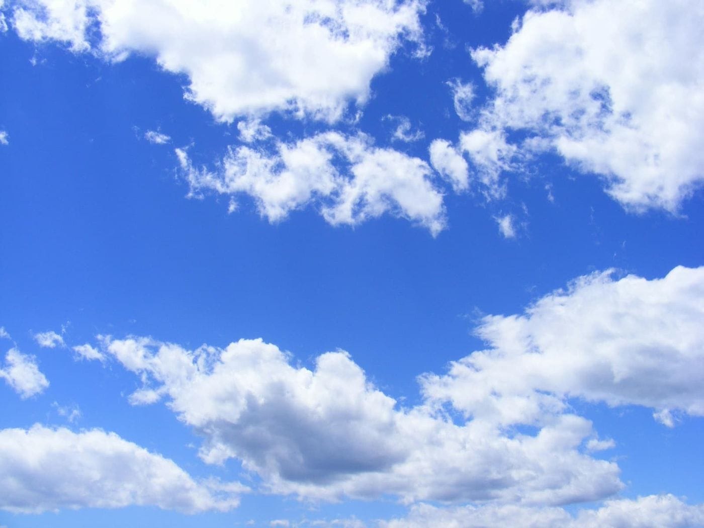 A bright blue sky with white clouds