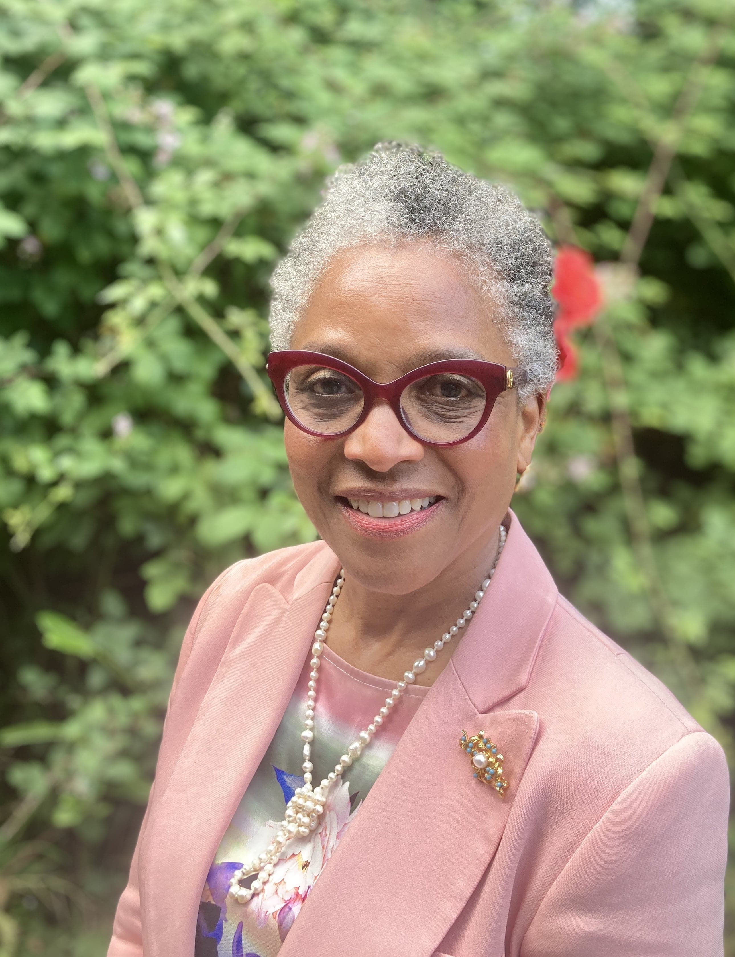 Head shot of Peaches Golding against a backdrop of greenery